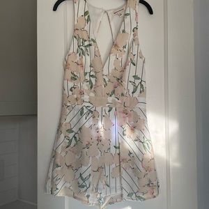 Short romper.  Pleated detail over shorts gives illusion of skirt.